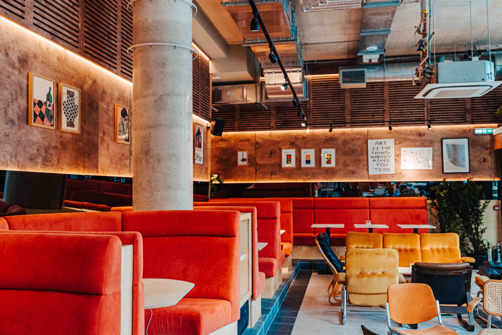 Orange velvet booths and lounge seating inside Someday bar, Finsbury Park